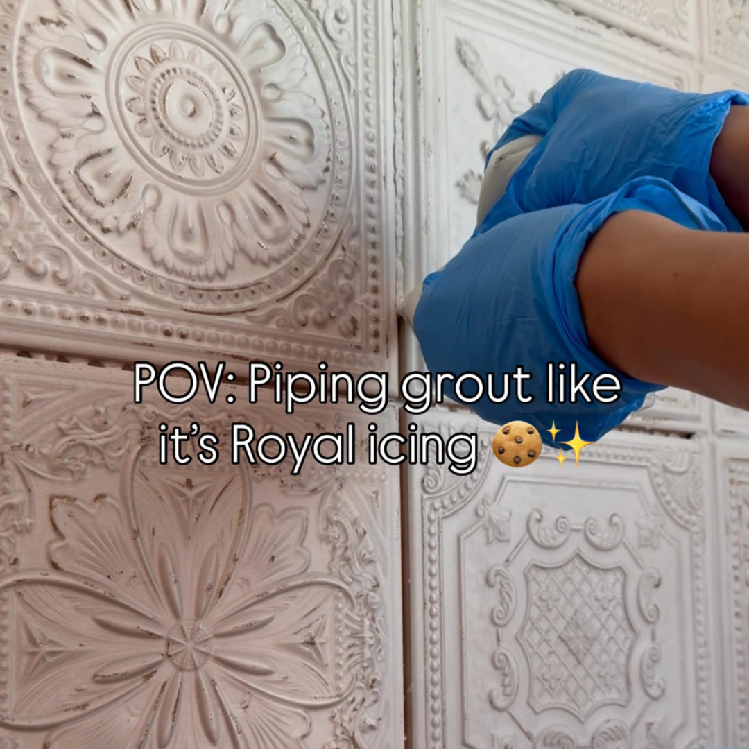 Close-up of DIY grout hack using sandwich bag piping on coffee bar backsplash tiles