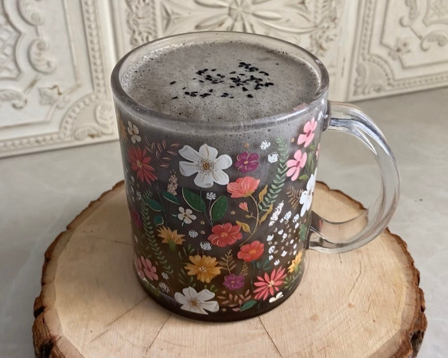 Black sesame latte in floral mug made with ZPlantMagic's coffee alternative, Koffee with a K for steady, nourishing energy without caffeine. 