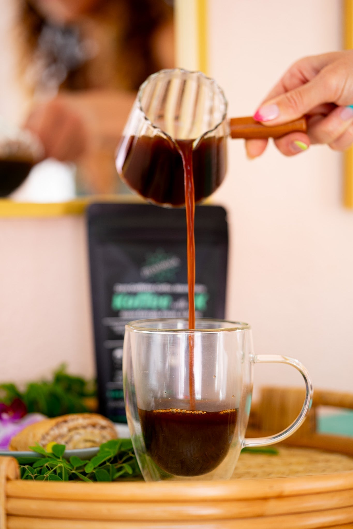 When you want to know if your mushroom coffee is caffeine-free. you have to take a closer look at the ingredients. Here a woman is carefully pouring freshly brewed caffeine free mushroom coffee by zplantmagic called Koffee with a K  into a mug.