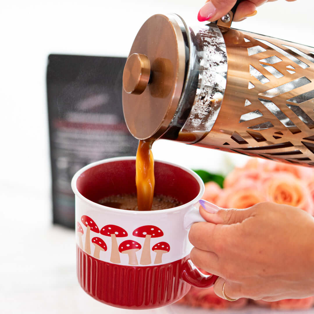 Hot chocolate mushroom koffee by zplantmagic being poured into a mushroom decorated mug for a caffeine-free morning ritual.