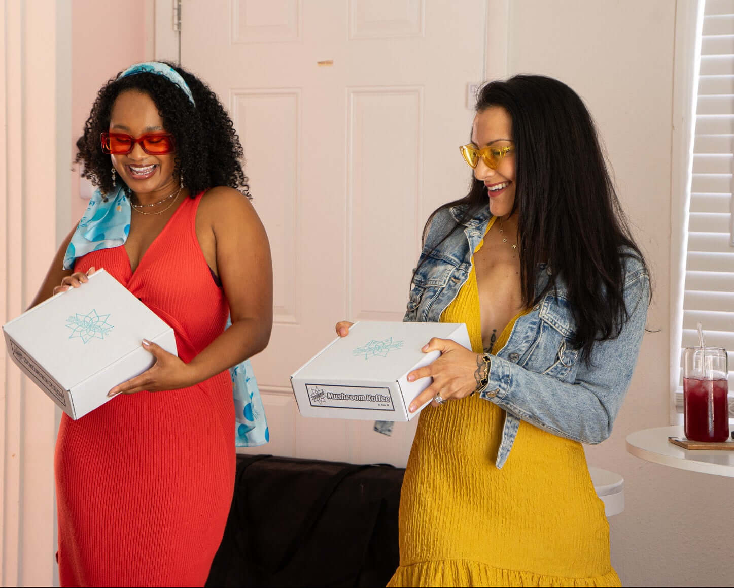 Two women smiling while opening a mushroom koffee subscription box from ZPlantMagic