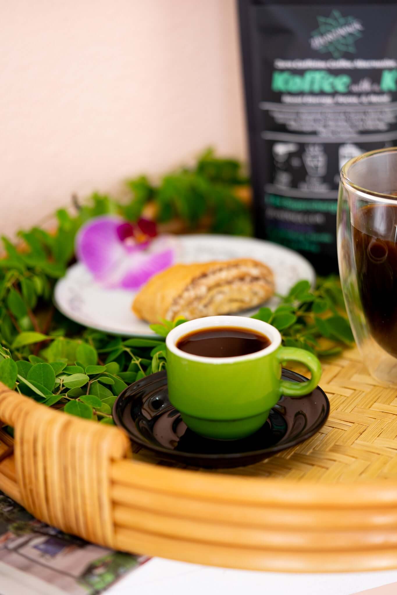 Mushroom herbal latte with fresh moringa on tray and a pastry for morning ritual