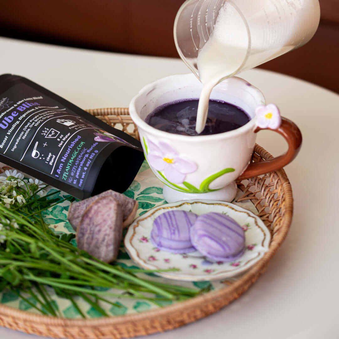 Milk poured into a warm Ube Bliss mushroom latte served in a floral mug as a cozy, caffeine-free ritual